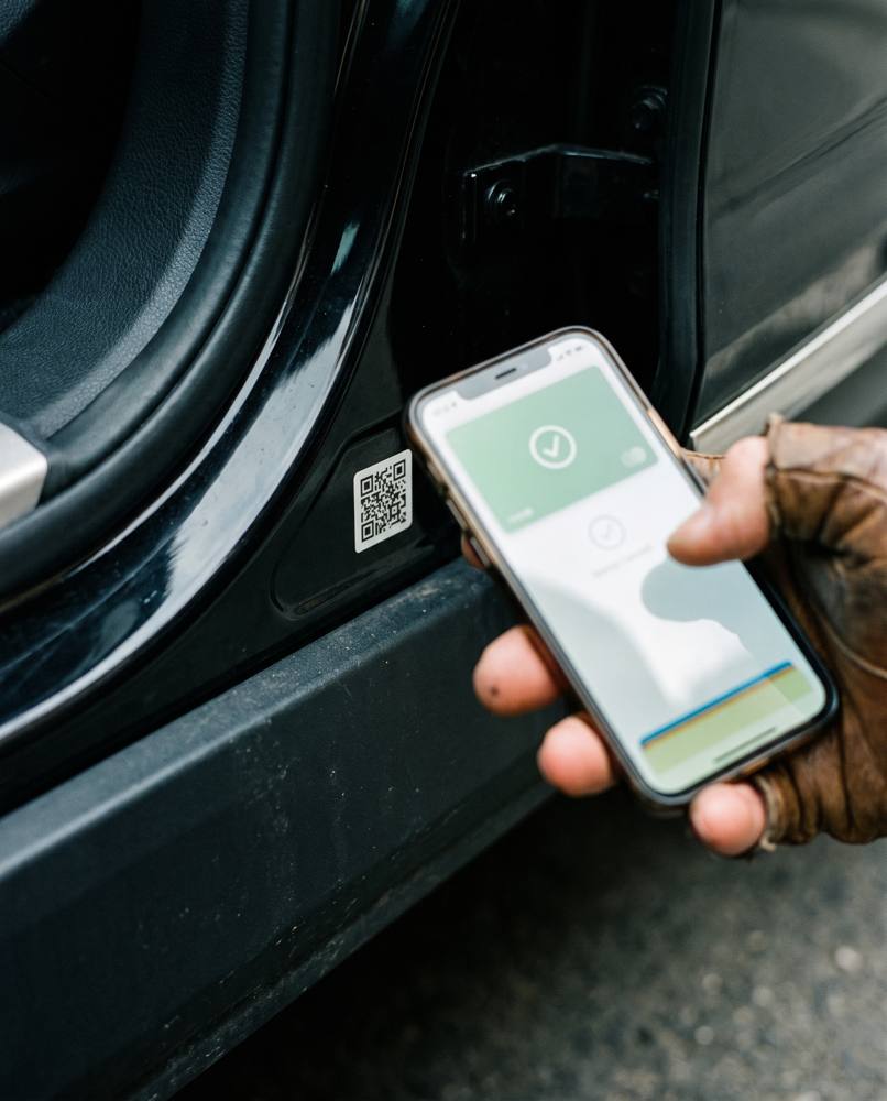 Phone scanning the NanoPro QR label on a car door sill